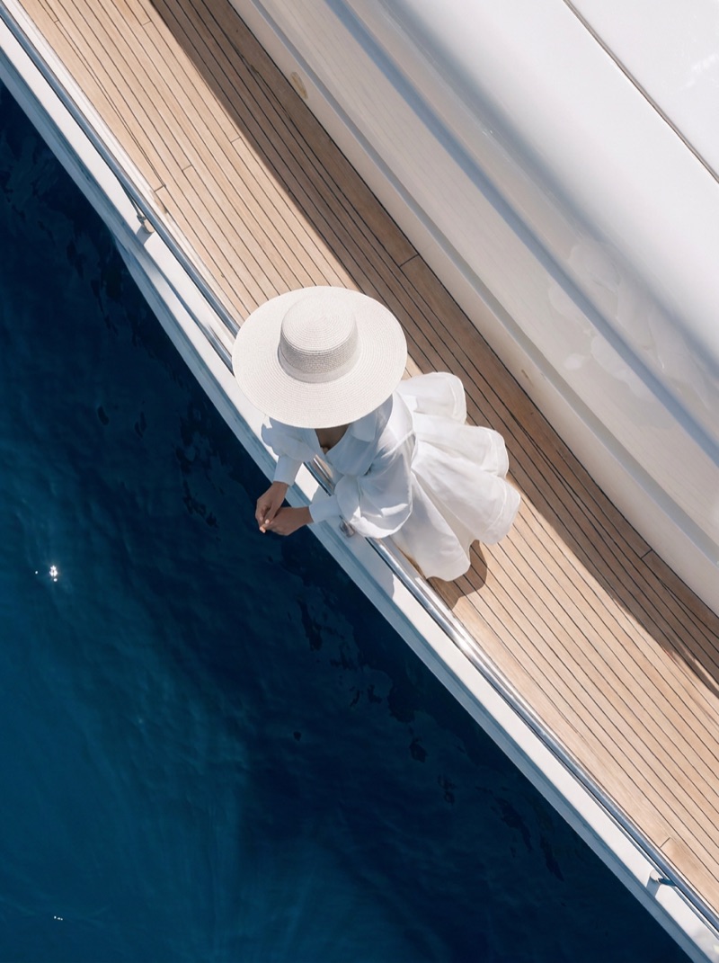 Overhead view of the model walking the yacht's side deck