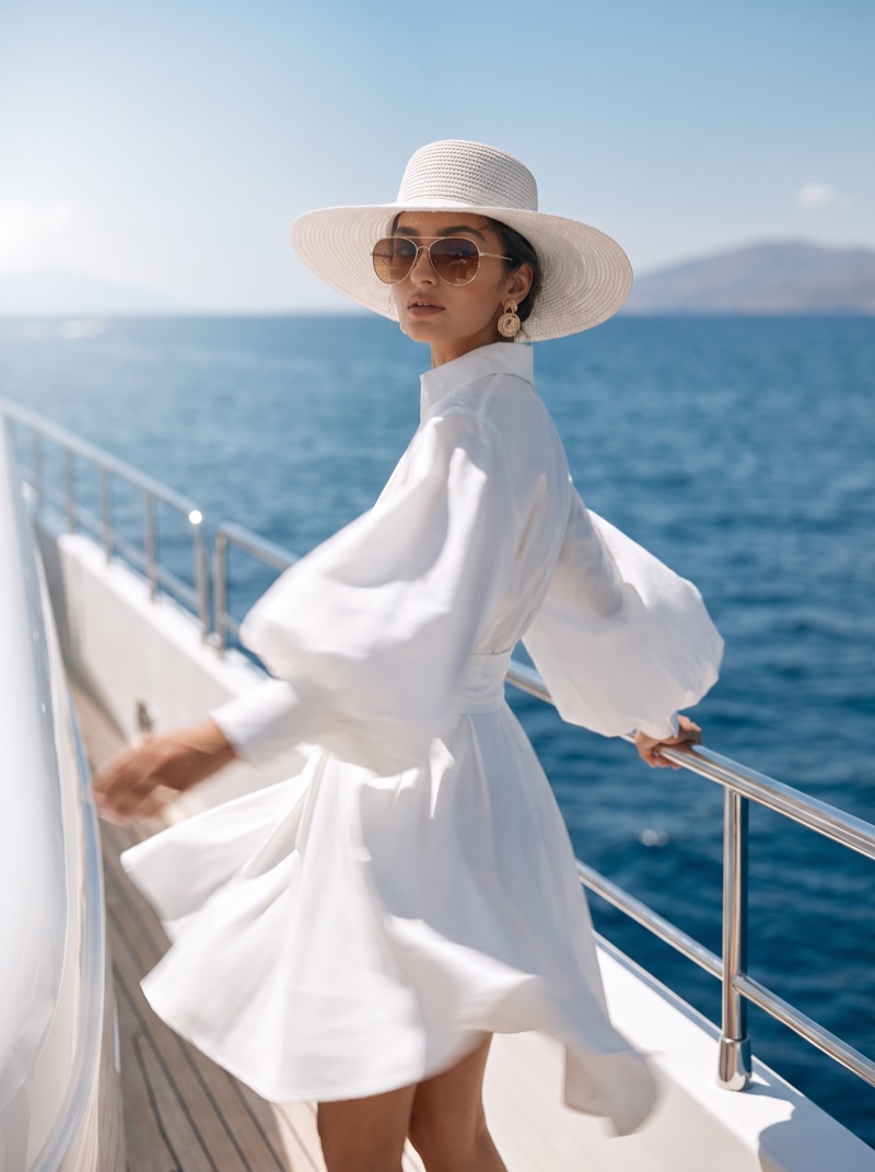 The model turning at the rail, skirt caught by the wind