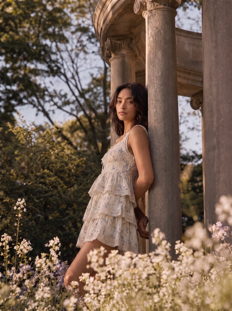 Previs frame: the model in a tiered white dress, leaning against a column of the rotunda