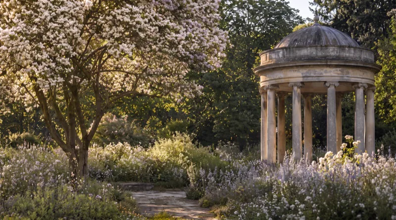 Location reference: a stone rotunda in a flowering garden at low sun